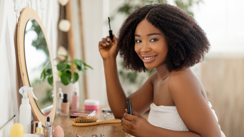 Woman holding mascara 