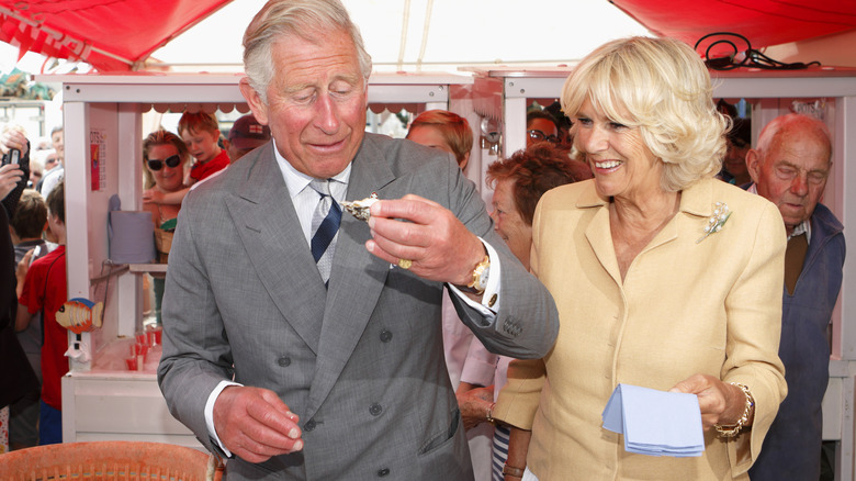 King Charles III and Queen Camilla enjoying oysters together