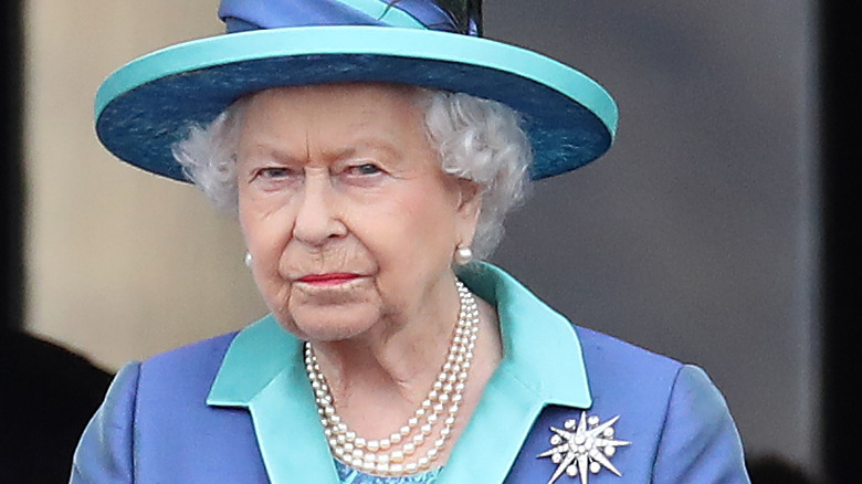 Queen Elizabeth II seemingly giving someone side-eye in an all-blue outfit