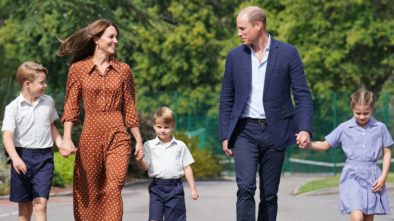 Catherine, Princess of Wales, and William, Prince of Wales, walking hand in hand with their children in September 2022