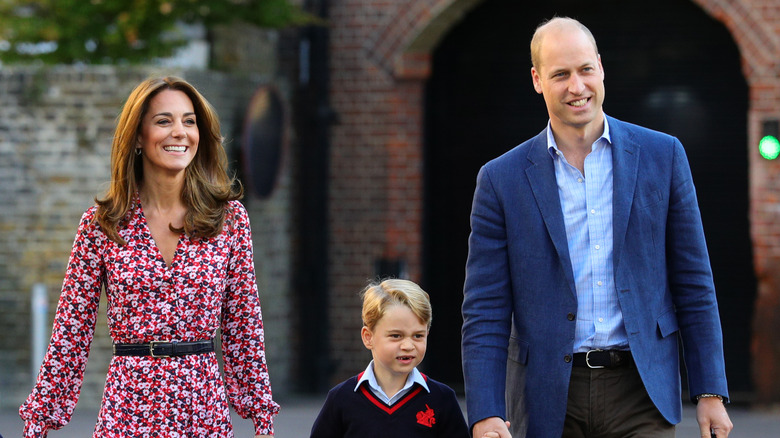 Kate Middleton, Prince George, Prince William smiling while walking