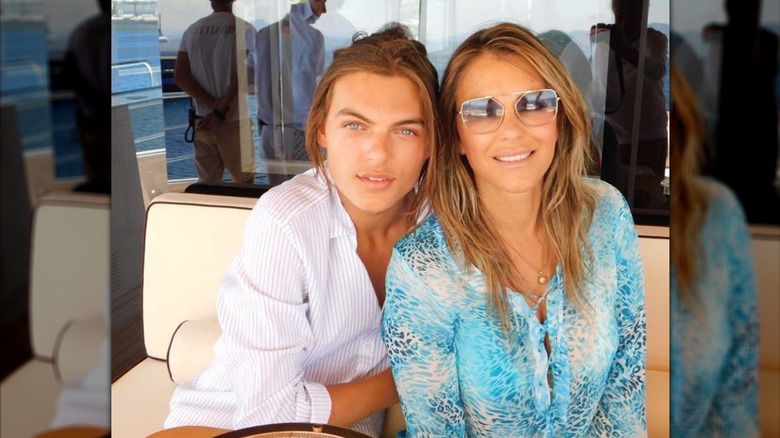 Damian Hurley and Elizabeth Hurley seated on a boat.