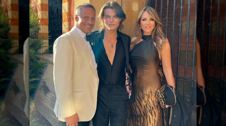 Damian Hurley posing between Arun Nayar and Elizabeth Hurley.