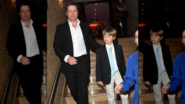 Hugh Grant and Damian Hurley walking down stairs.