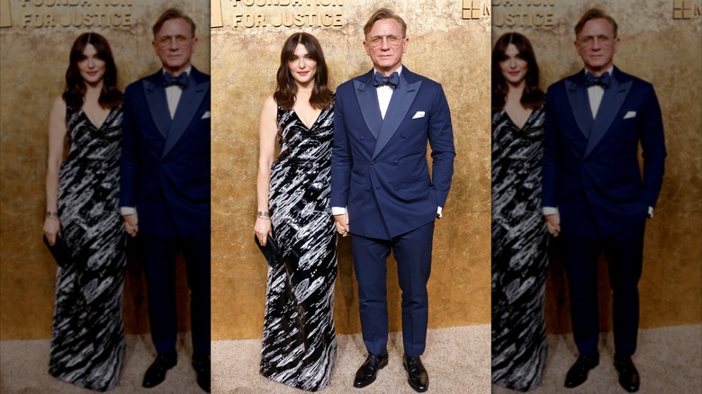 Rachel Weisz in a black and white dress with Daniel Craig on the red carpet