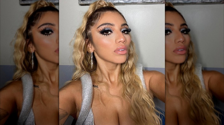 Kirstin Maldonado taking a selfie of her long, wavy, blond hair and silver makeup for the 2020 Billboard Music Awards