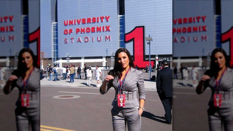 Molly Qerim stands in front of a stadium in 2007 for the SuperBowl wearing a gray suit jacket.