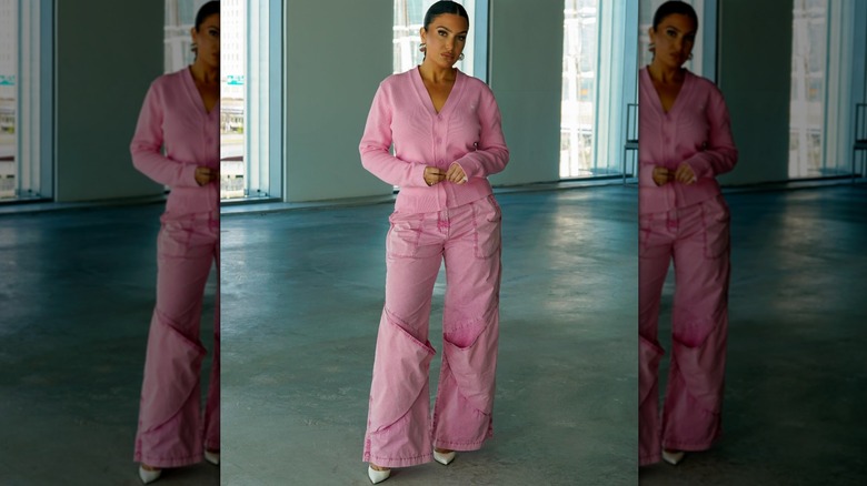 Molly Qerim posing in pink outfit and white heels