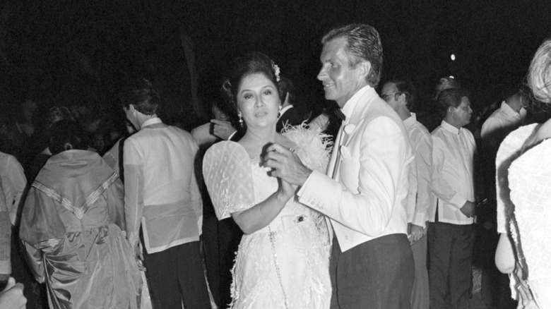 Imelda Marcos and George Hamilton dance at a Filipino tribe festival in 1983