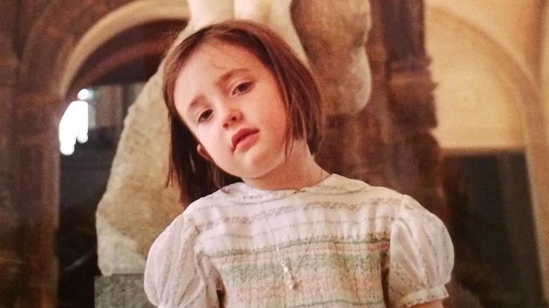 Angelica Jopling as a child posing in a museum