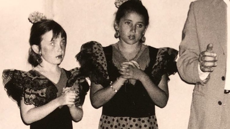 Angelica Jopling standing next to Vivenne Westwood's granddaughter as children dressed up in a black and white old photo
