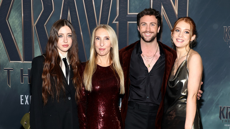 Aaron Taylor-Johnson and his wife and stepdaughters smiling at the 