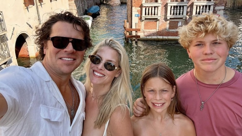 Angela Larter posing for a selfie in Venice with her husband and children