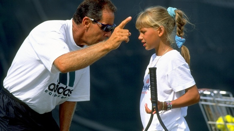 Man coaching young Anna Kournikova