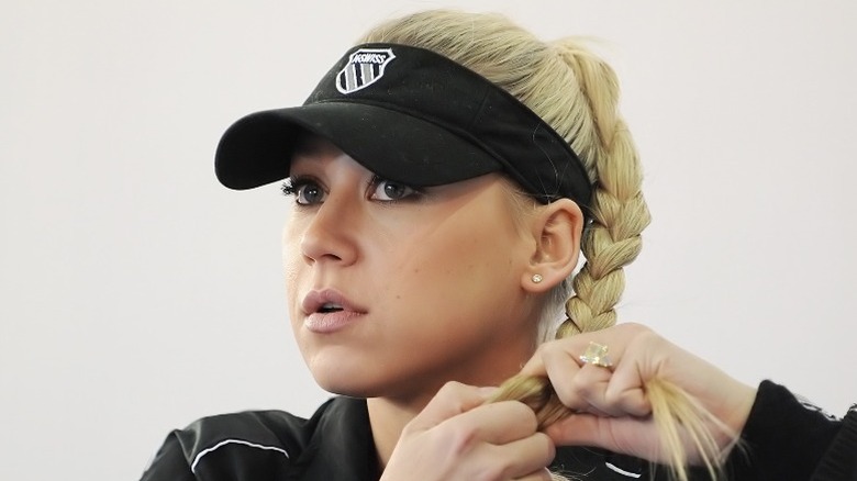 Anna Kournikova braiding her hair in 2009