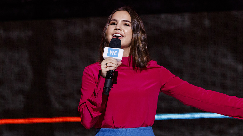 Bailee Madison singing into a microphone