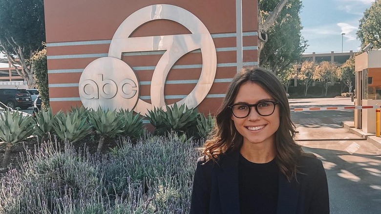 Sophie Flay smiles standing outside of the ABC7 studio lot in LA.