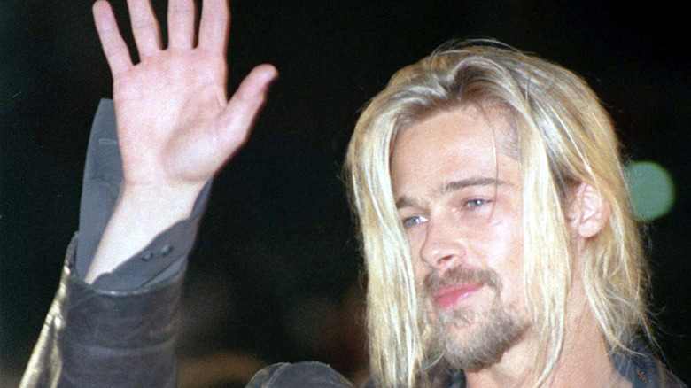 Brad Pitt with long hair, waving
