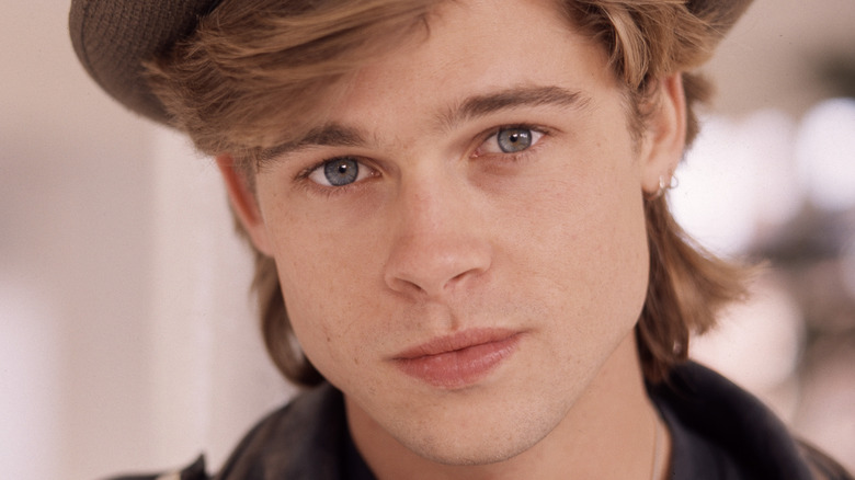 A young Brad Pitt wearing hat
