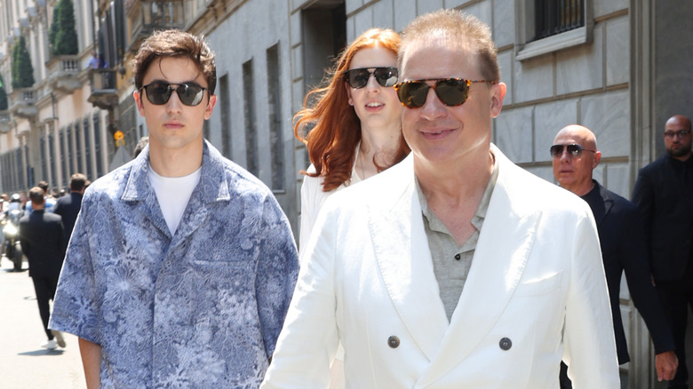 Brendan Fraser's sons walk behind him outside wearing sunglasses