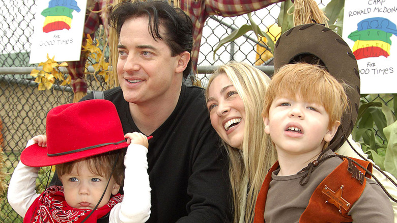 Brendan Fraser, his wife, and their two oldest sons pose for a picture at a fall event when the boys were young