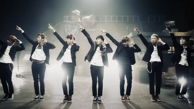 BTS performing in a music video.