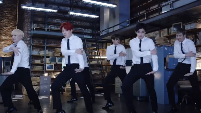 BTS performing in a music video.