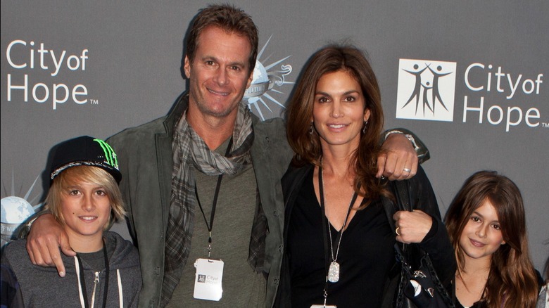Presley Gerber, Rande Gerber, Cindy Crawford, and Kaia Gerber smiling at an event the same year as Kaia's first Versace campaign.