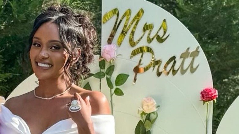 CNN's Rahel Solomon smiles in front of a white sign that says "Mrs. Pratt"