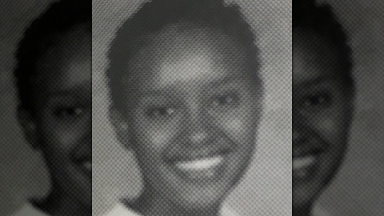 Rahel Solomon smiles in a black and white high school yearbook picture with short hair.