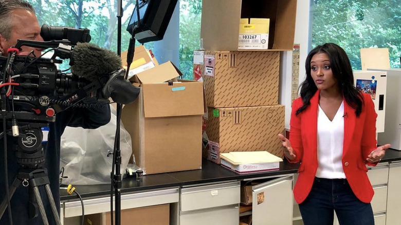 Rahel Solomon wears a red jacket and looks into a camera with a serious expression on her face