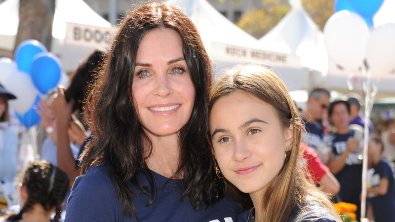 Coco Arquette and Courteney Cox dancing