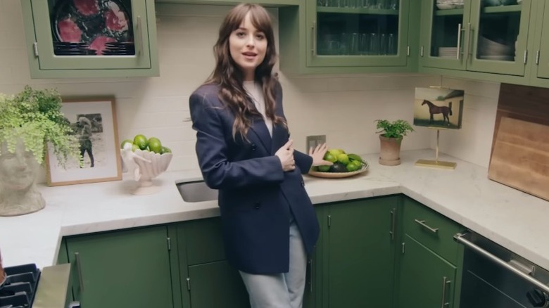 Dakota Johnson showing off limes in a bowl on her counter