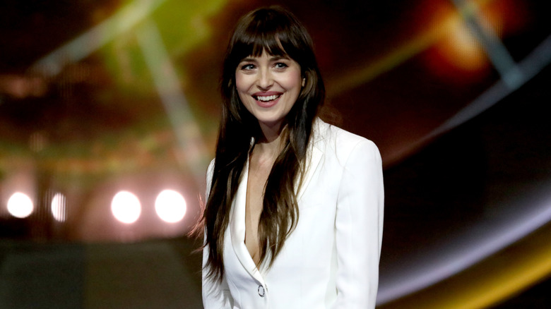 Dakota Johnson smiling on stage