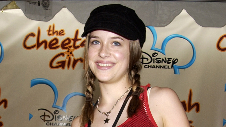 A teenaged Dakota Johnson posing at Disney event