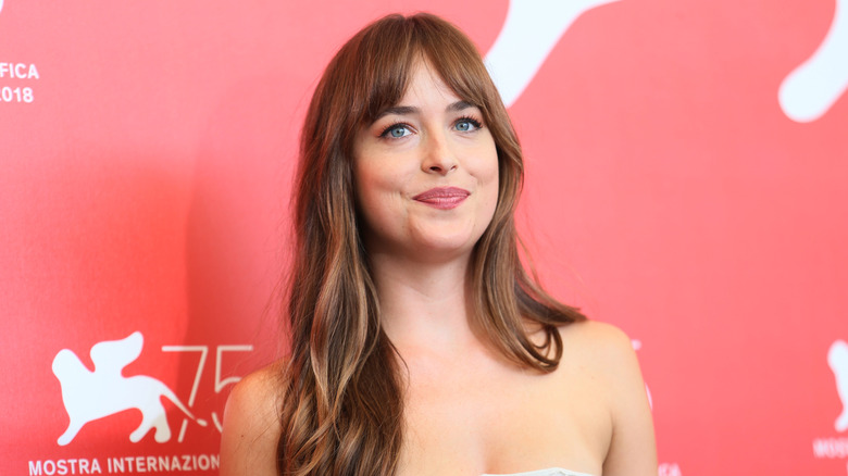 Dakota Johnson posing on step-and-repeat