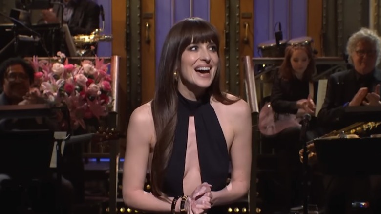 Dakota Johnson laughing during her monologue on "SNL" in 2024