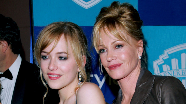 Melanie Griffith and Dakota Johnson posing on step-and-repeat