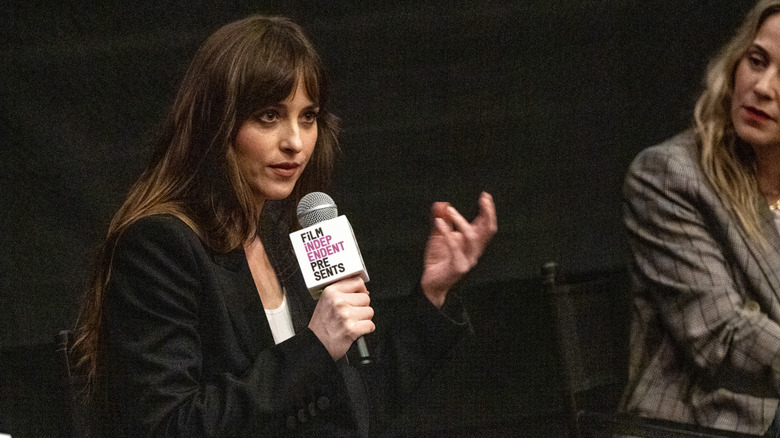 Dakota Johnson speaking into mic at event