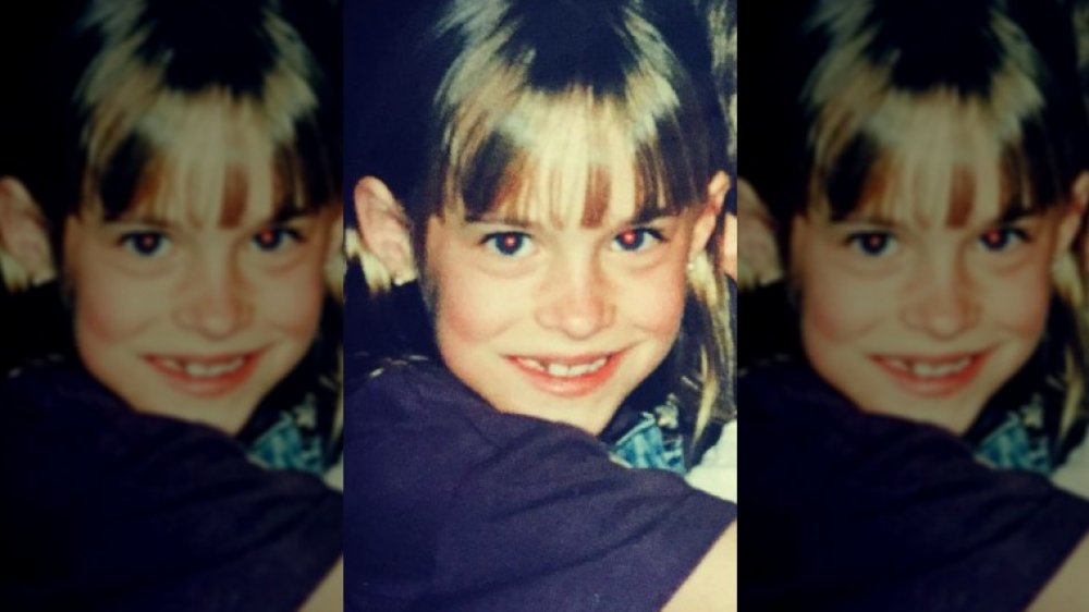 Dakota Johnson as a child smiling