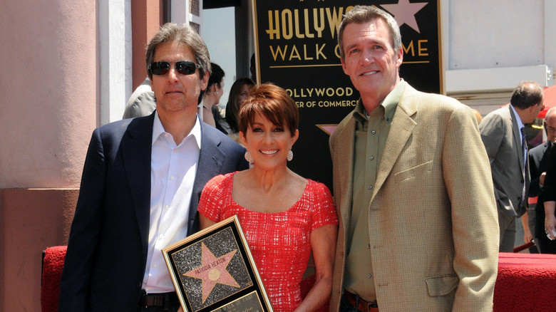 Standing between Ray Romano and Neil Flynn, Patricia Heaton is holding her star on the Hollywood Walk of Fame in 2012