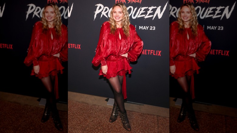 Natalie Alyn Lind wearing a short dress with a layered skirt and puffy sleeves.