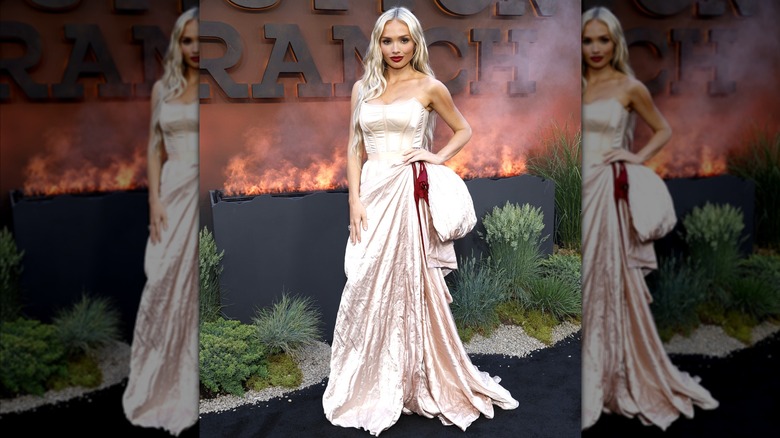 Natalie Alyn Wood wearing a white corseted dress.