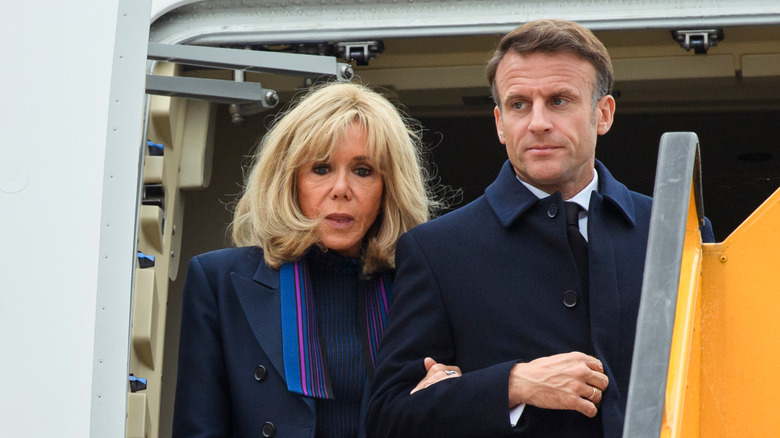 Brigitte and Emmanuel Macron exiting a plane