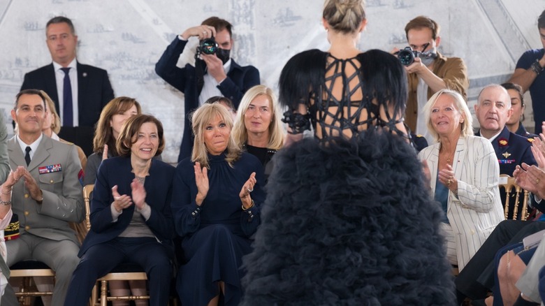 Brigitte Macron clapping in audience at Paris Fashion Week in 2021