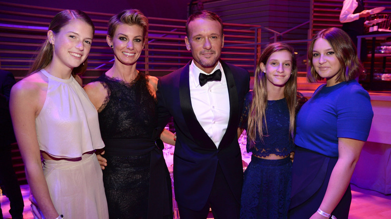 Faith Hill, Tim McGraw, and their three daughters at an event