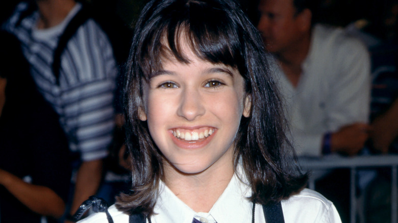 Lacey Chabert smiling against Christmas backdrop