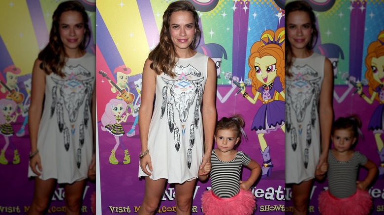 Bethany Joy Lenz holding her daughter's hand and posing in 2014