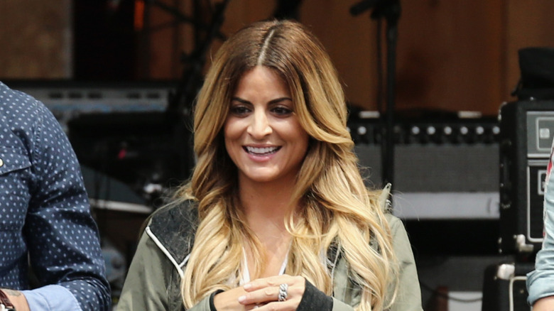 Alison Victoria smiling onstage in 2015