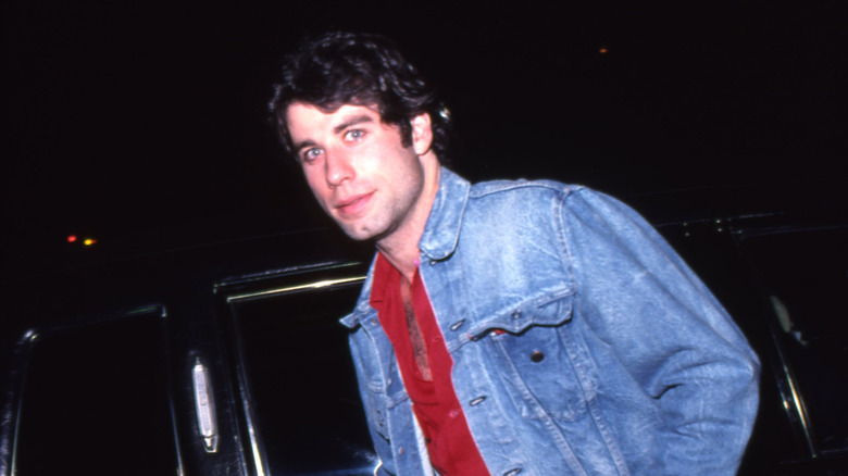 John Travolta getting in a car